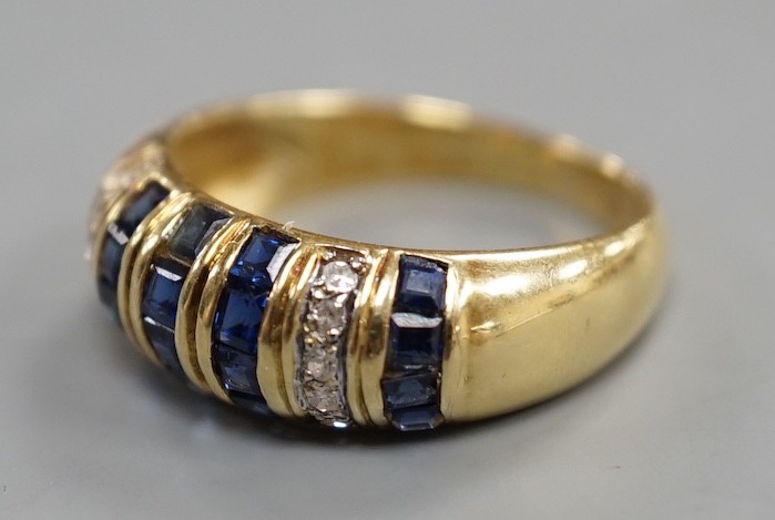 A modern yellow metal, sapphire chip and diamond chip set half hoop cluster ring, size M/N, ross weight 3.6 grams(two sapphires missing).